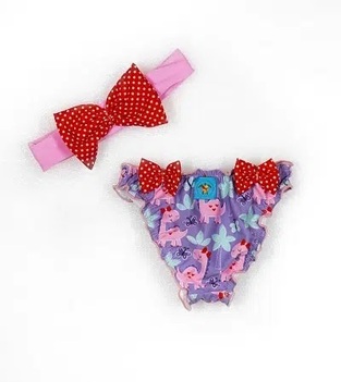 TORTUE monokini swimsuit in purple color with dinosaur print and ribbon.