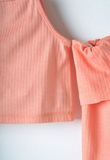 EBITA pants set in orange color with striped design.