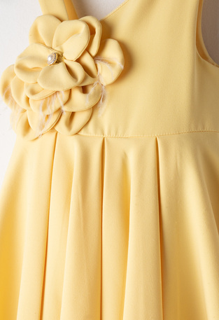 Φόρεμα ΕΒΙΤΑ σε χρώμα κίτρινο, με διακοσμητικό τρισδιάστατο λουλούδι στο μπροστινό μέρος.