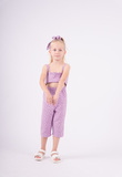 Purple EBITA jumpsuit with matching hair scrunchie.