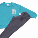 TRAX suit set in emerald color with "REAL SKATER" logo.