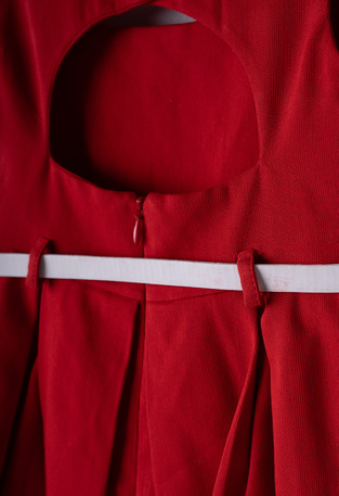 EBITA dress in red with pleats.