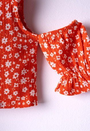 EBITA shorts set in orange color with all over floral pattern.