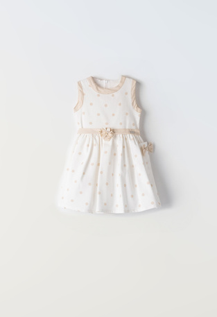 EBITA dress in off-white color with all over beige polka dot pattern.