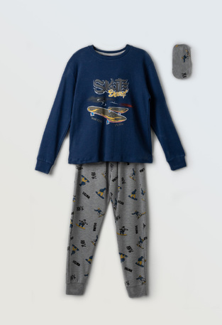 HOMMIES pajamas in blue with an embossed skateboard print and matching sleep mask.