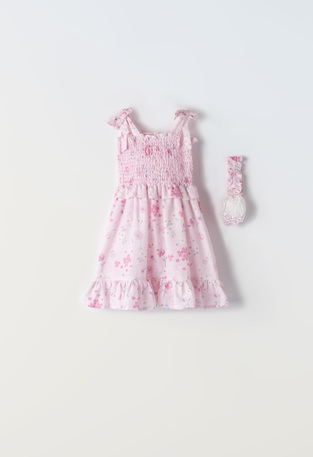 EBITA dress in pink color with floral design.