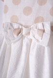 EBITA dress in white color with polka dots pattern.
