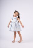 EBITA dress in siel color with striped pattern and impressive bow.