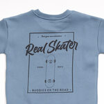 TRAX suit set in petrol color with "REAL SKATER" logo.