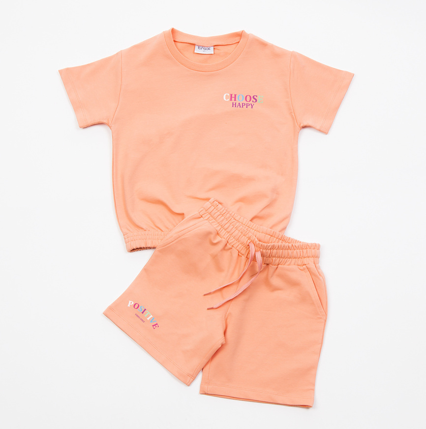 Σετ σορτς TRAX, μπλούζα με τύπωμα και σορτς σε χρώμα πορτοκαλί.
