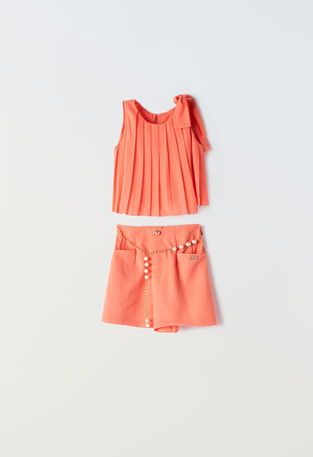 EBITA shorts set in peach color with pleated fabric.