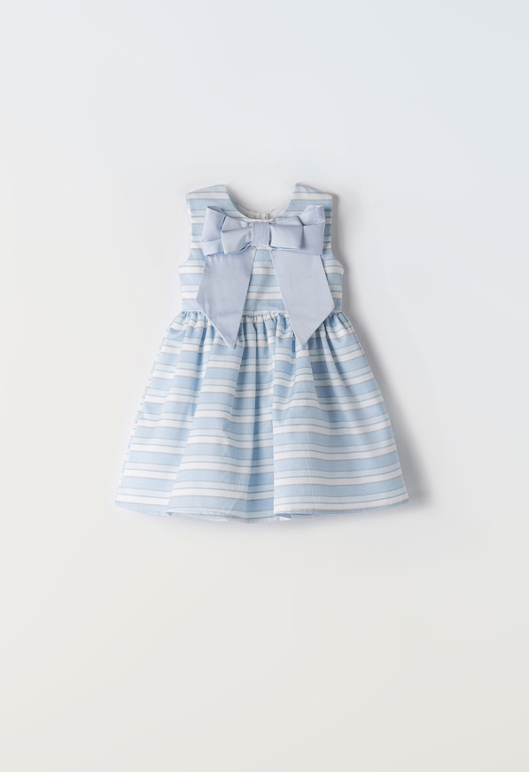 EBITA dress in siel color with striped pattern and impressive bow.