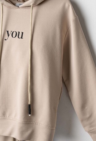 Evita seasonal jumpsuit set in beige.