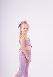 Purple EBITA jumpsuit with matching hair scrunchie.